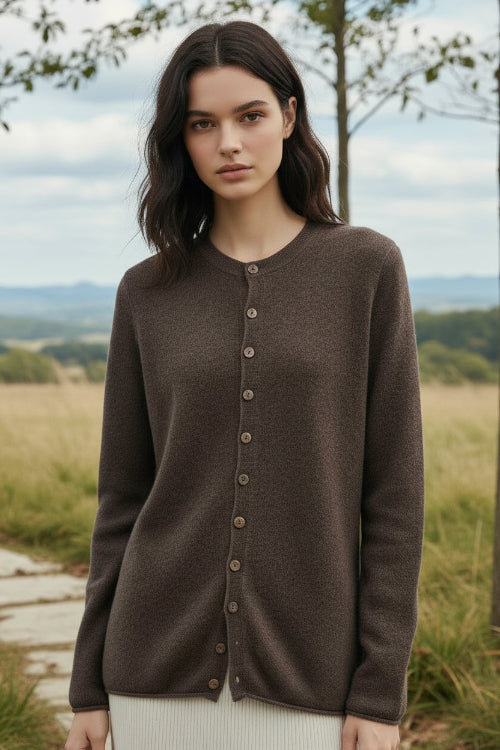 Person wearing a brown button-up cardigan in a clothing store setting