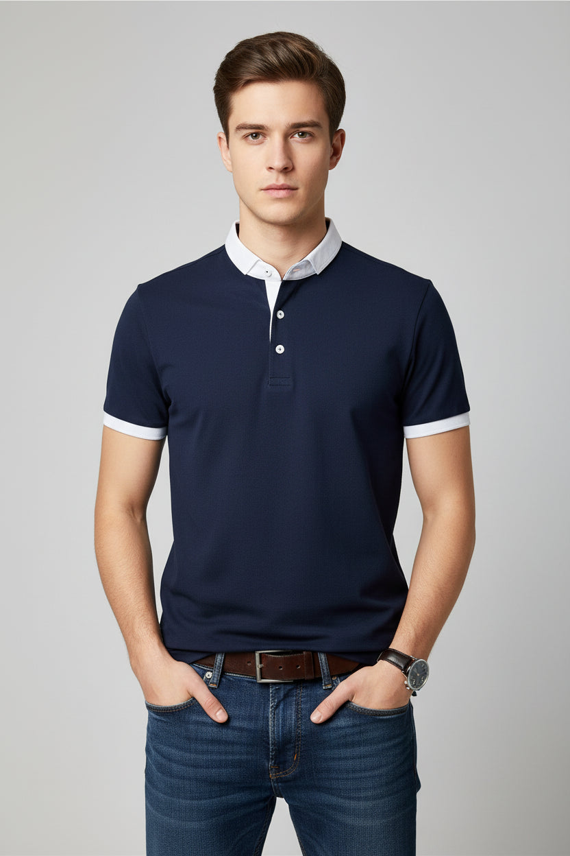 Navy blue polo shirt with white trim worn by a person on a gray background
