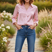 Woman wearing a pink leopard print shirt against a plain background