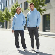 Light blue hoodie worn by a person on a white background