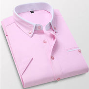 Pink dress shirt with white collar and buttons on a light gray background