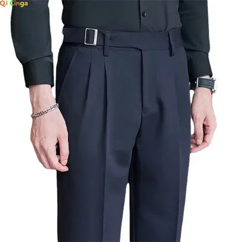 Dark gray pleated pants worn by a person on a white background