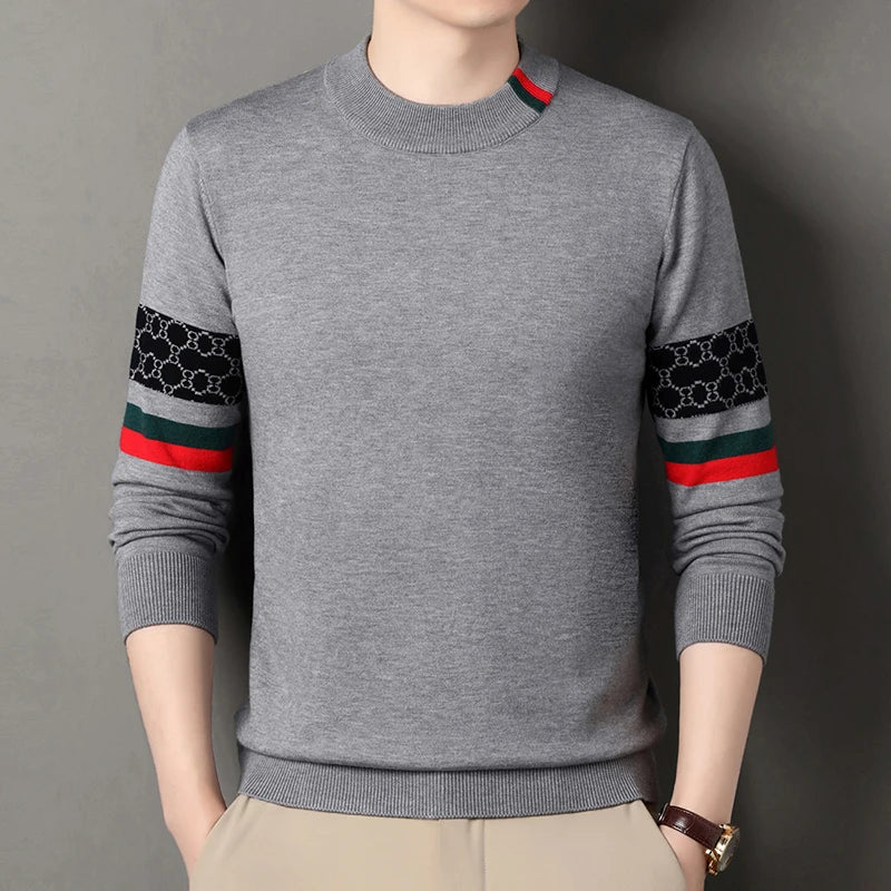 Gray sweater with patterned sleeves on a gray background