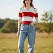 A woman wearing a short-sleeve knit polo shirt with bold horizontal red and off-white stripes, seated indoors.