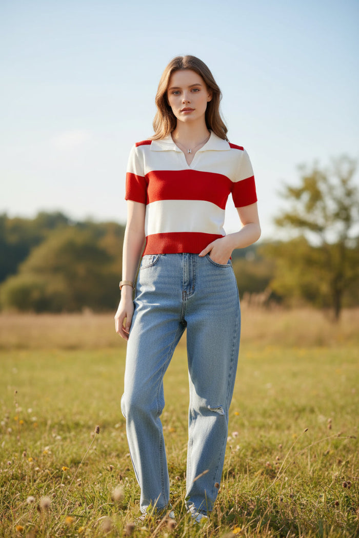 A woman wearing a short-sleeve knit polo shirt with bold horizontal red and off-white stripes, seated indoors.