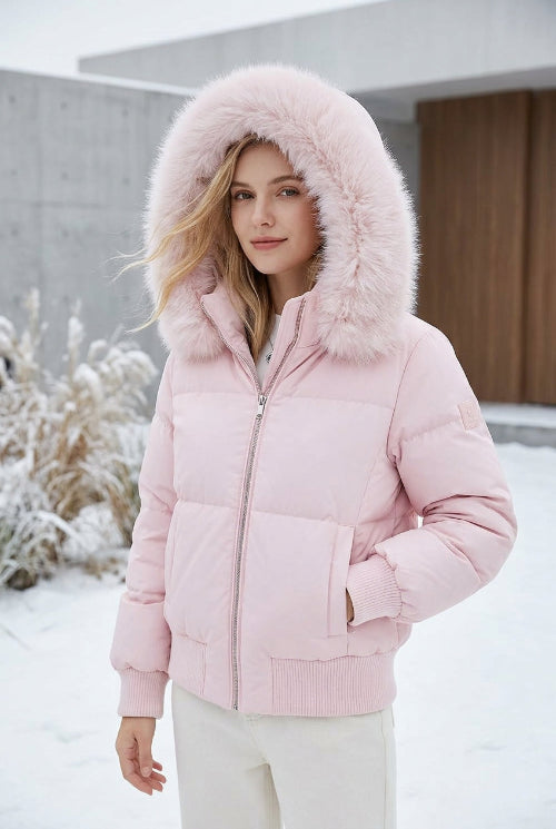 A light pink puffer jacket with a large fluffy faux-fur trimmed hood, displayed on a mannequin torso in an indoor boutique setting.