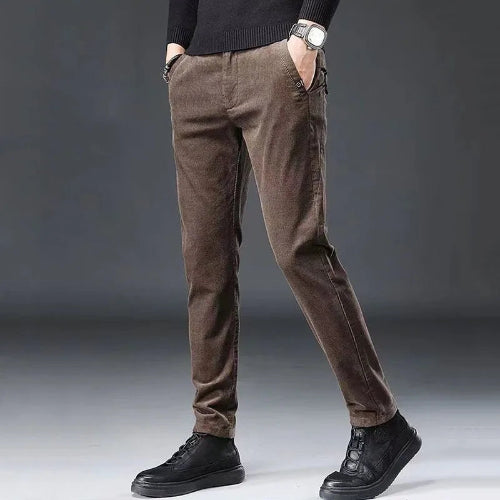 Brown pants worn by a person on a gray background