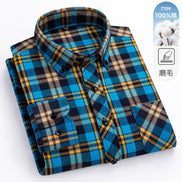 Folded plaid shirt with blue, brown, and yellow pattern on a white background