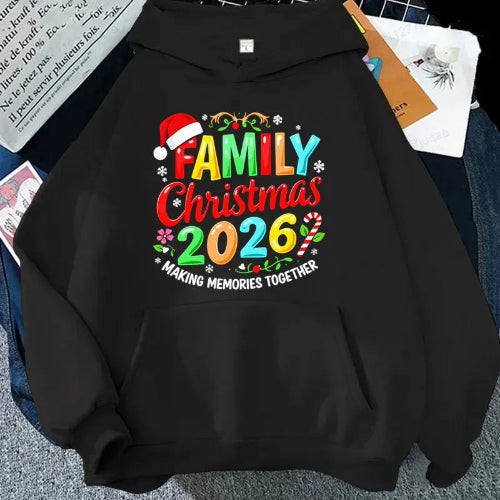 A black hoodie laid flat with a colorful Christmas-themed graphic reading 'FAMILY Christmas 2026' and 'MAKING MEMORIES TOGETHER.' The design includes multicolored lettering, candy cane accents, snowflakes, and a red Santa hat.
