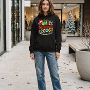 A black hoodie laid flat with a colorful Christmas-themed graphic reading 'FAMILY Christmas 2026' and 'MAKING MEMORIES TOGETHER,' 