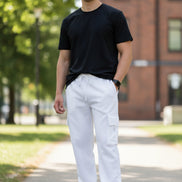 Person wearing white cargo pants and black shirt on a plain background