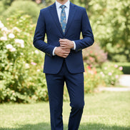 Navy blue suit with a white shirt, patterned tie, and brown shoes on a white background