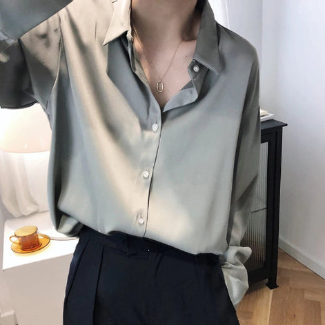 Gray satin blouse worn by a model taking a mirror selfie.