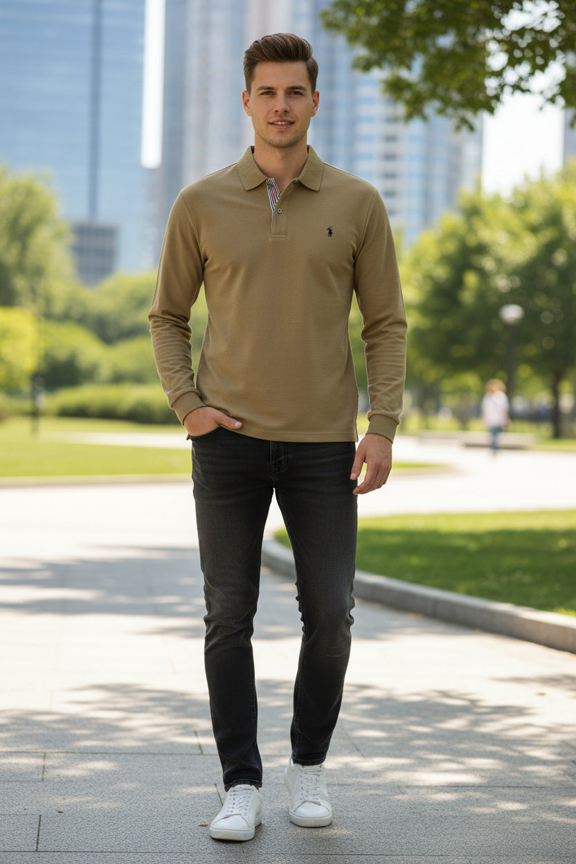 Beige polo shirt with brand logo held by a hand against a blurred clothing rack background