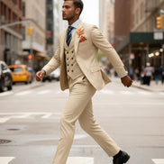 Man in a beige suit walking on a city street