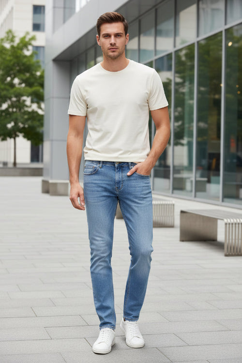 Light blue denim jeans folded to show the back pocket and waistband, with a tan leather patch reading FASHION JEANS.
