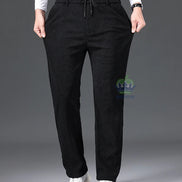 Person wearing black pants with a gray background