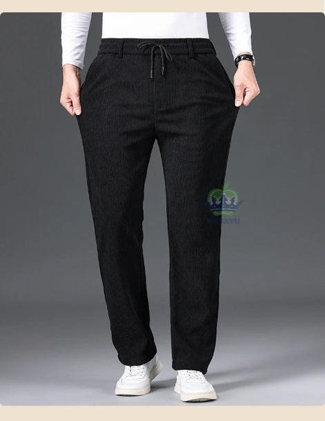 Person wearing black pants with a gray background