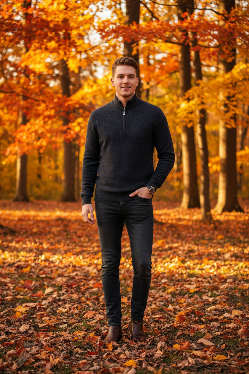 Dark gray half-zip sweater and watch on a gray surface