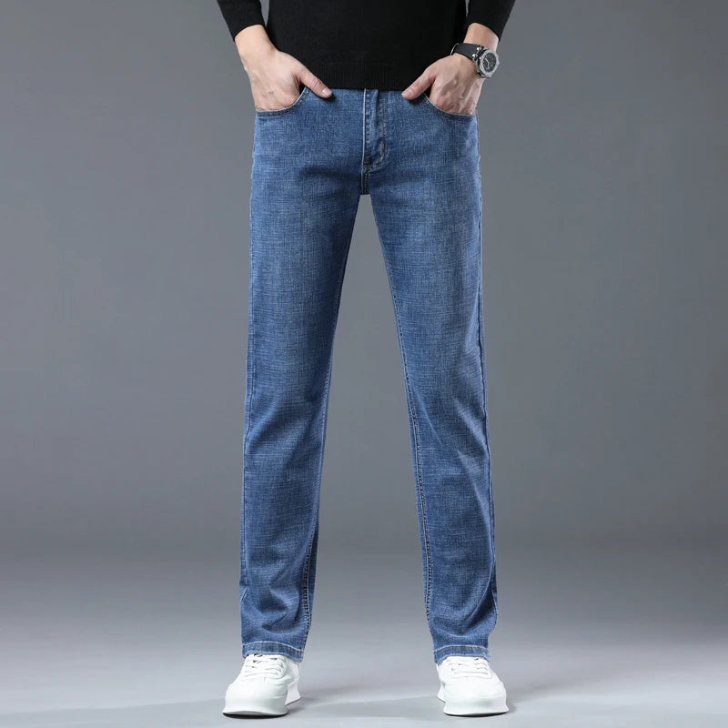 Person wearing blue jeans on a gray background