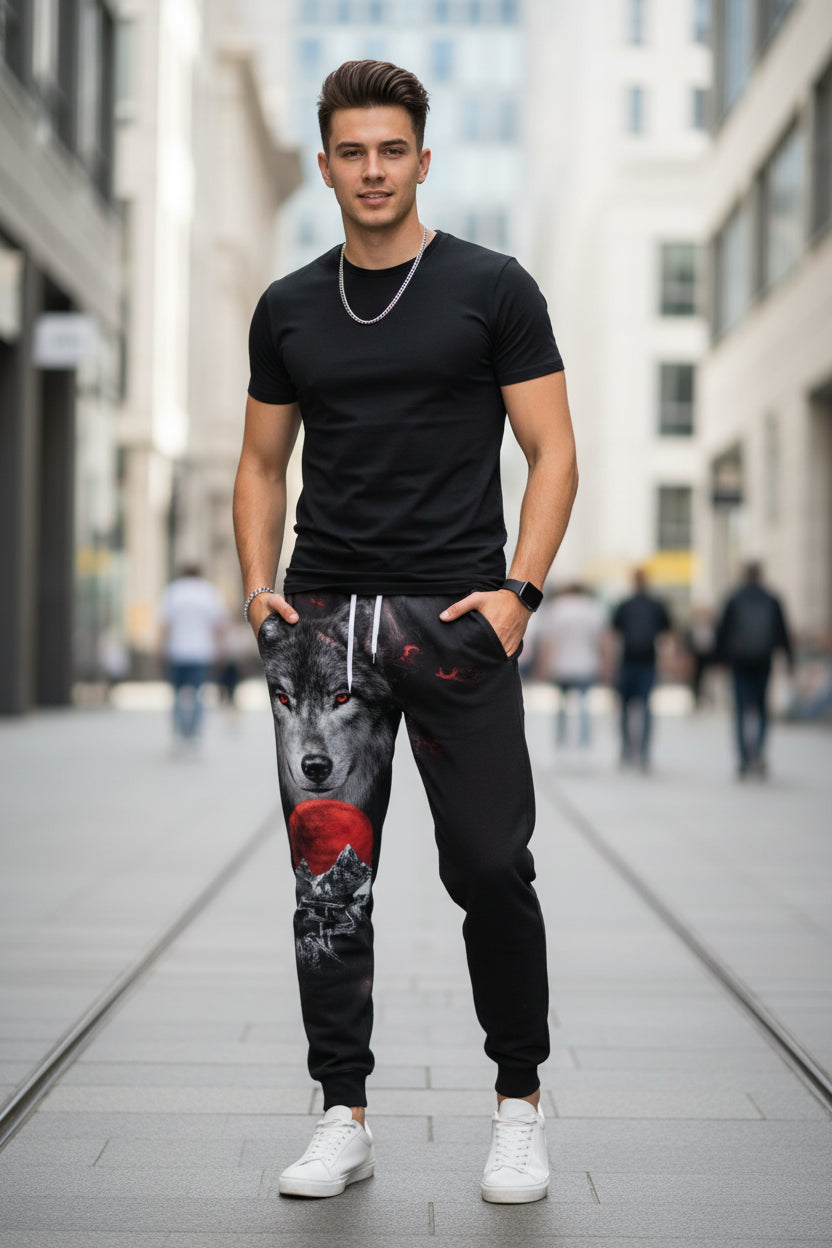 Black sweatpants with wolf and moon design on a white background