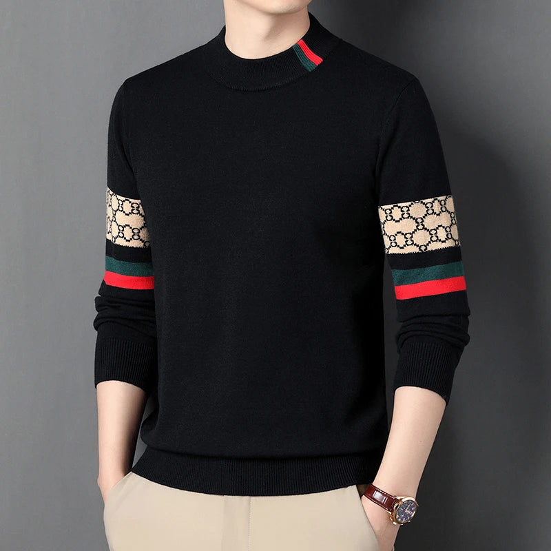 Black sweater with patterned sleeves worn by a person on a gray background
