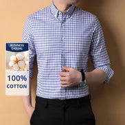 Person wearing a blue and white checkered shirt with a label indicating 100% cotton and business casual suitability.