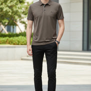 Brown polo shirt worn by a person on a gray background