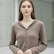 Beige cardigan worn by a person with a blurred background