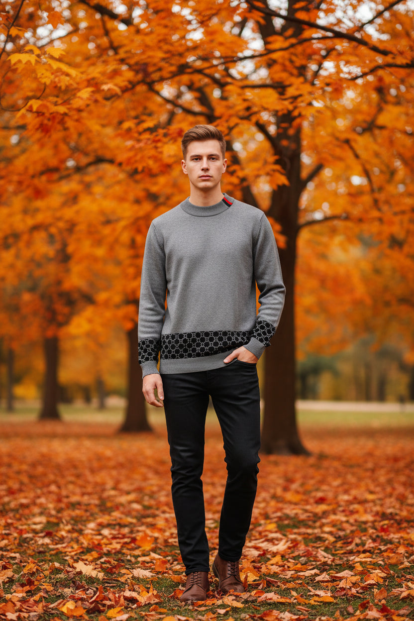 Gray sweater with a hand touching the fabric on a gray background