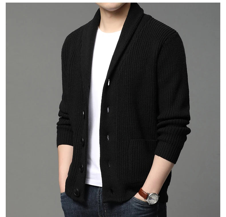 Black cardigan over a white shirt on a gray background