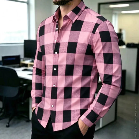 A man wearing a pink and black buffalo check long-sleeve button-down shirt in an office environment.