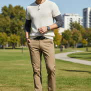 Person wearing khaki pants with a gray background