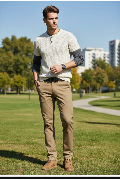 Person wearing khaki pants with a gray background