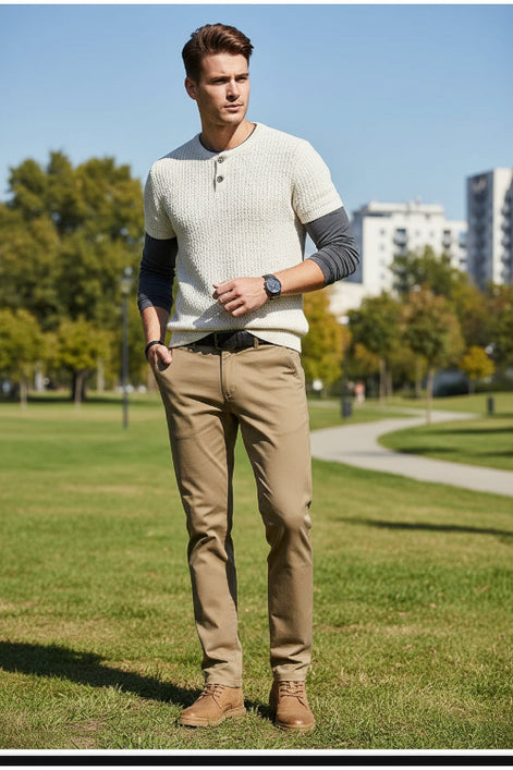 Person wearing khaki pants with a gray background