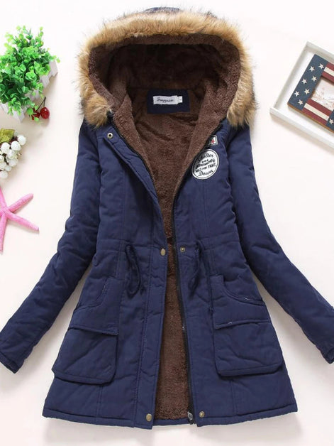 Blue winter coat with fur-lined hood on a white background