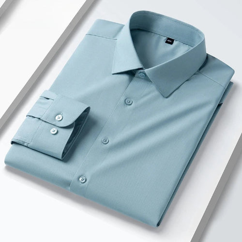 A folded light blue long-sleeve dress shirt with a pointed collar and button-down front, shown on a clean white background with diagonal gray graphic lines.
