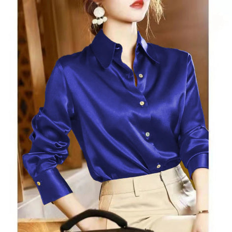 Blue satin shirt worn by a person with a blurred background