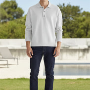 Person wearing a light gray long-sleeve polo shirt against a beige background