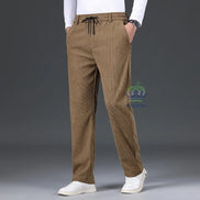 Brown pants worn by a person on a gray background
