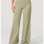 Green wide-leg pants worn by a person on a white background