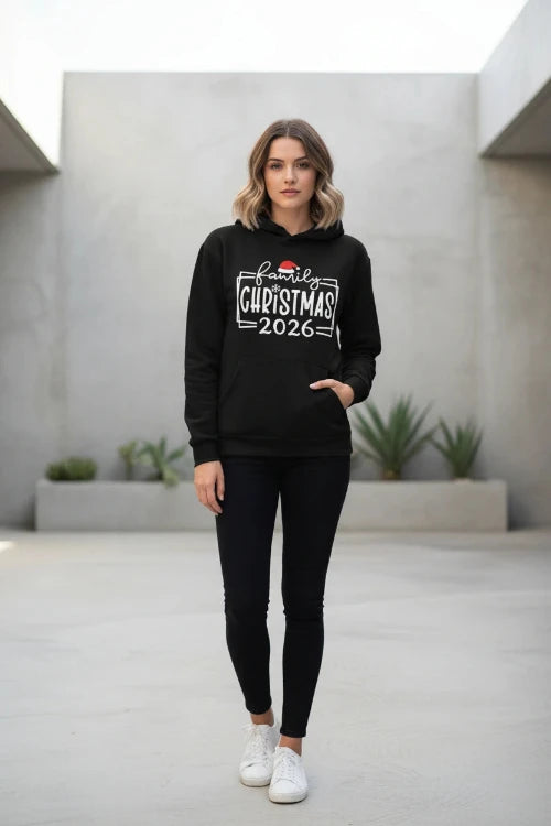 A black pullover hoodie laid flat with a festive white graphic reading 'family Christmas 2026' and a small Santa hat accent, 