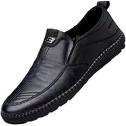 Black leather loafer shoe on a white background