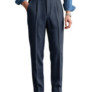 Navy blue herringbone pleated suit trousers shown on a white background