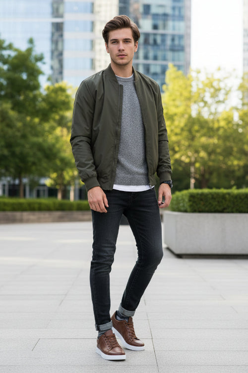 Brown leather sneakers with white soles on a reflective surface and gray background