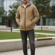 Beige hoodie with black zipper and orange accents on a white background