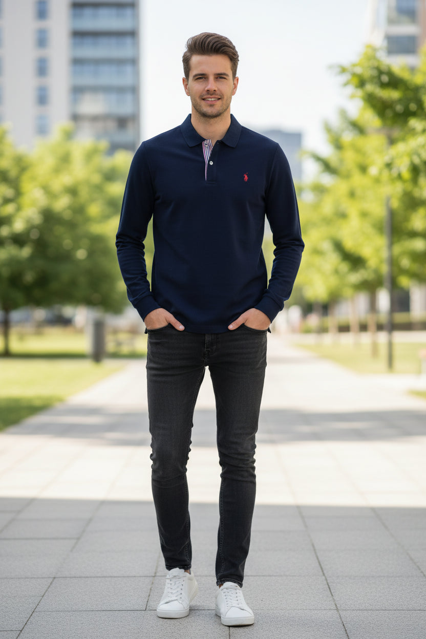 Navy blue polo shirt with a red logo on a hanger against a background of other colored shirts.