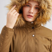 Person wearing a brown coat with a fur-lined hood on a light gray background