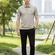 Beige polo shirt with a brand logo on a gray background