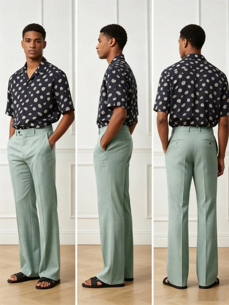 A three-view model photo showing a man wearing sage green wide-leg trousers and a navy short-sleeve button-up shirt with white polka dots, standing against a white paneled wall.